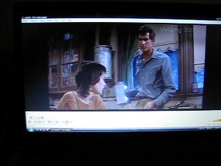 a television screen showing two people on a tv