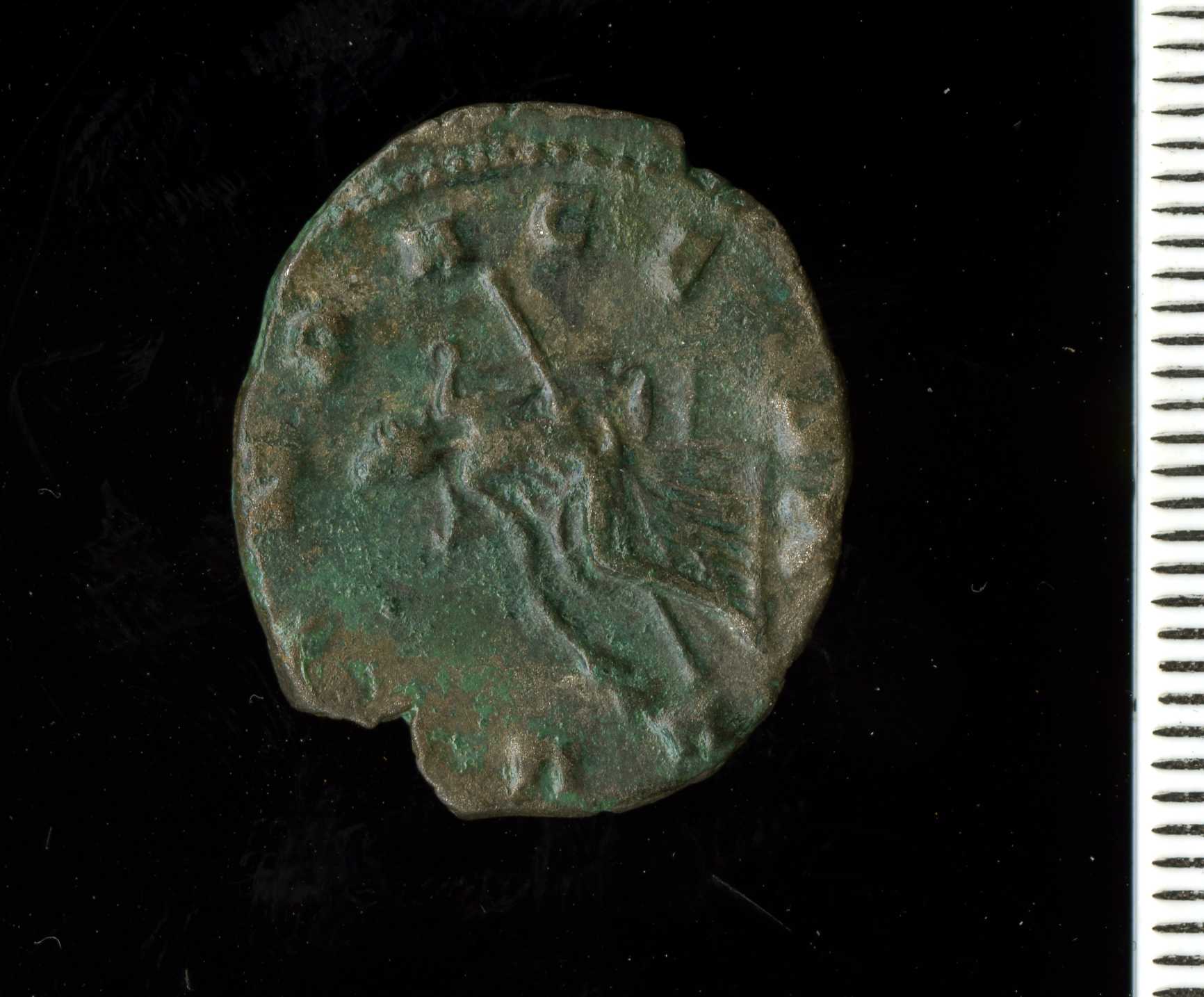 a green colored coin has faded edges and a woman's head