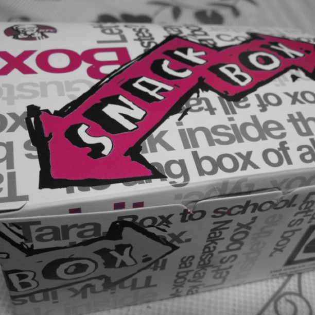 a box is open with a pink sticker