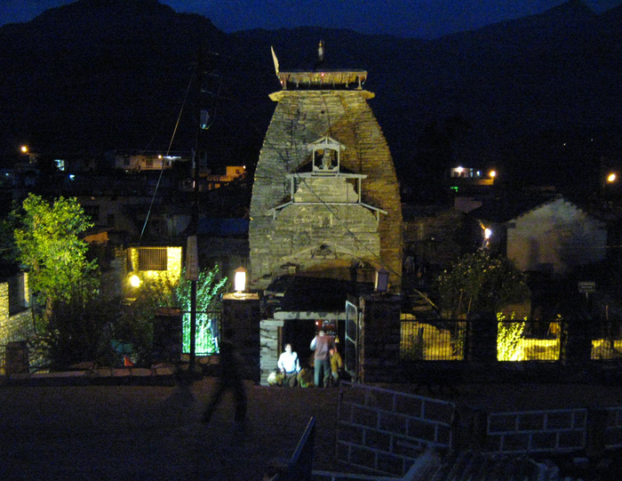 people outside of an old building in the dark