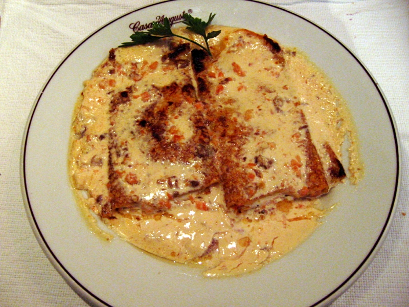 a dinner plate with food and utensils set on a table