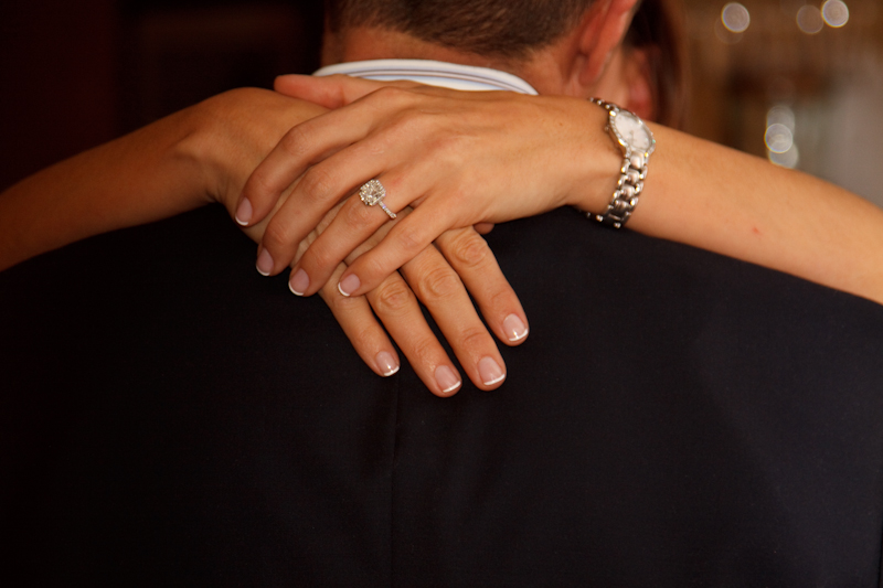 a couple is hugging while they have their hands around each other