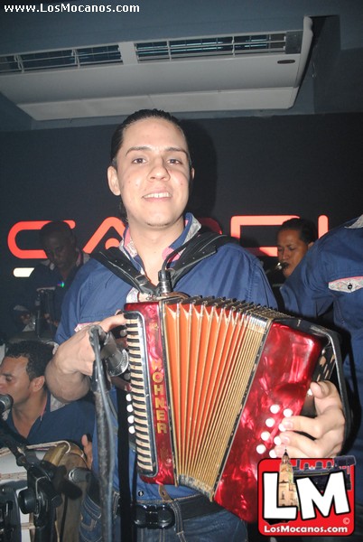 man playing the accordeoon in a crowded room