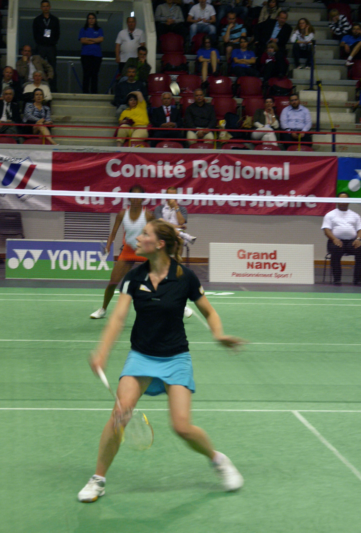 a lady that is playing tennis on a court