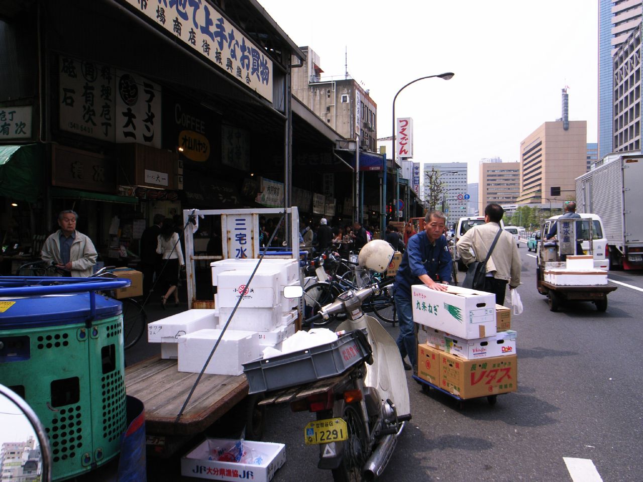 many people are on the street shopping and some with luggage