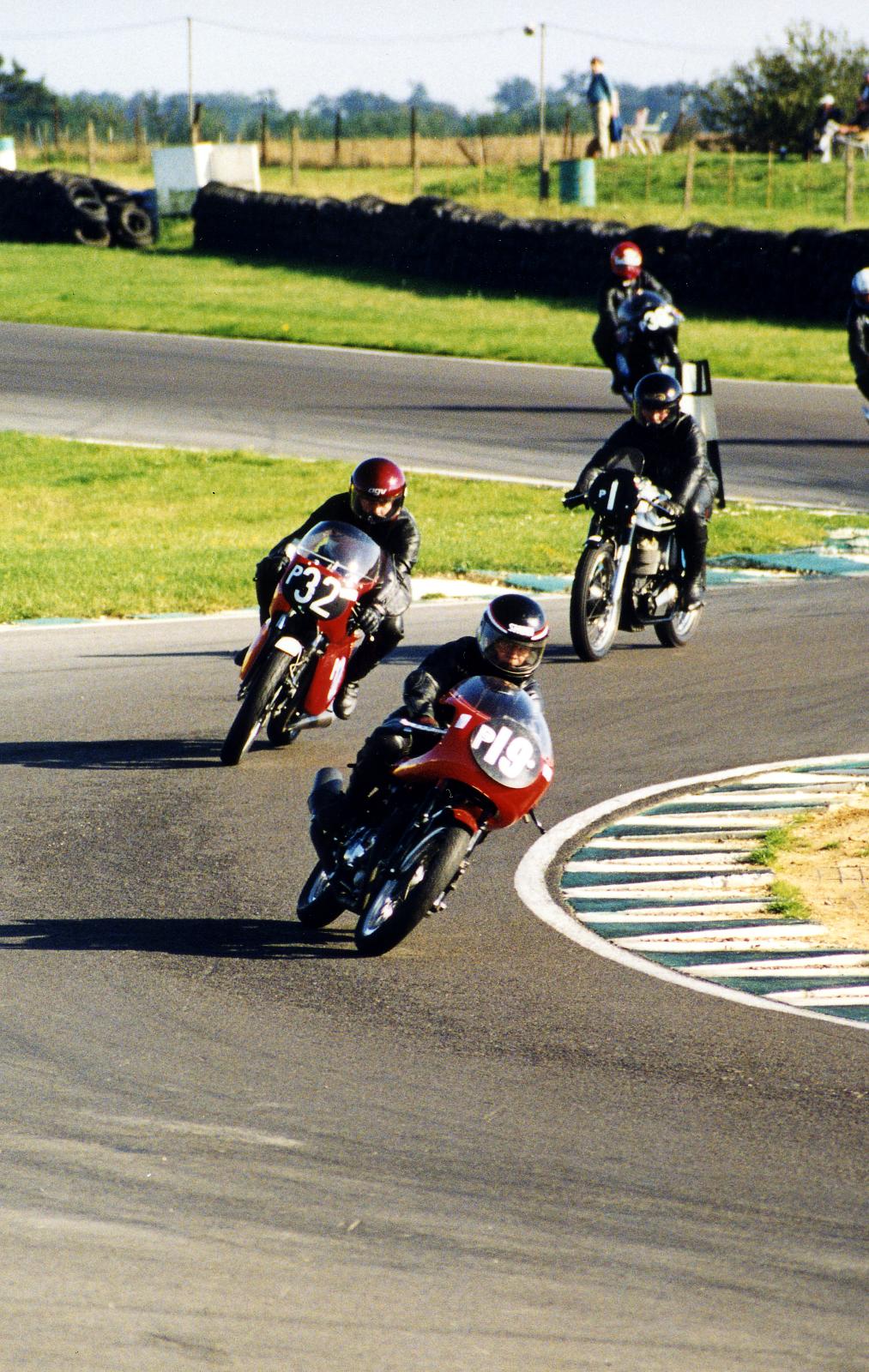 a group of people racing motorcycles on a track