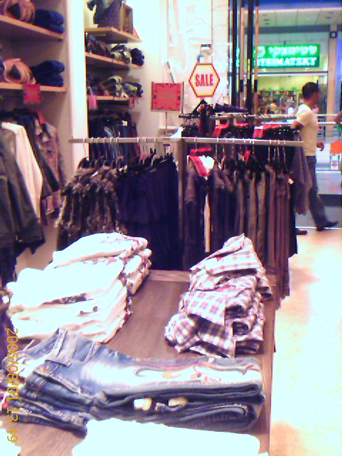 men's clothes are displayed in a shop