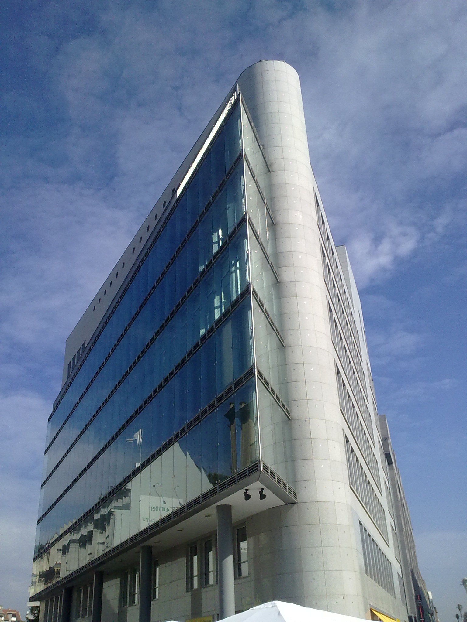 the building has multiple floors and glass windows