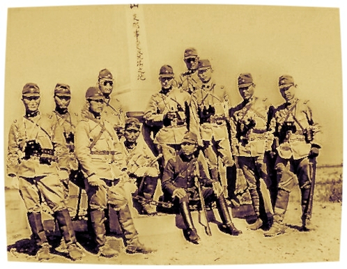 group of soldiers posing in military clothes, holding rifles and helmets