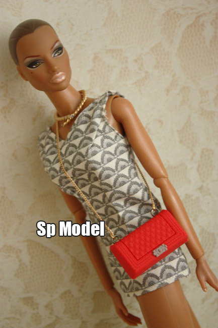 a barbie doll with an elegant dress and a purse