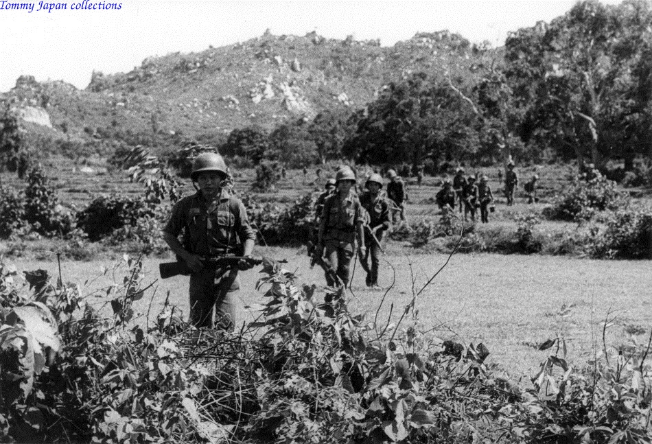 a bunch of soldiers that are walking in the dirt