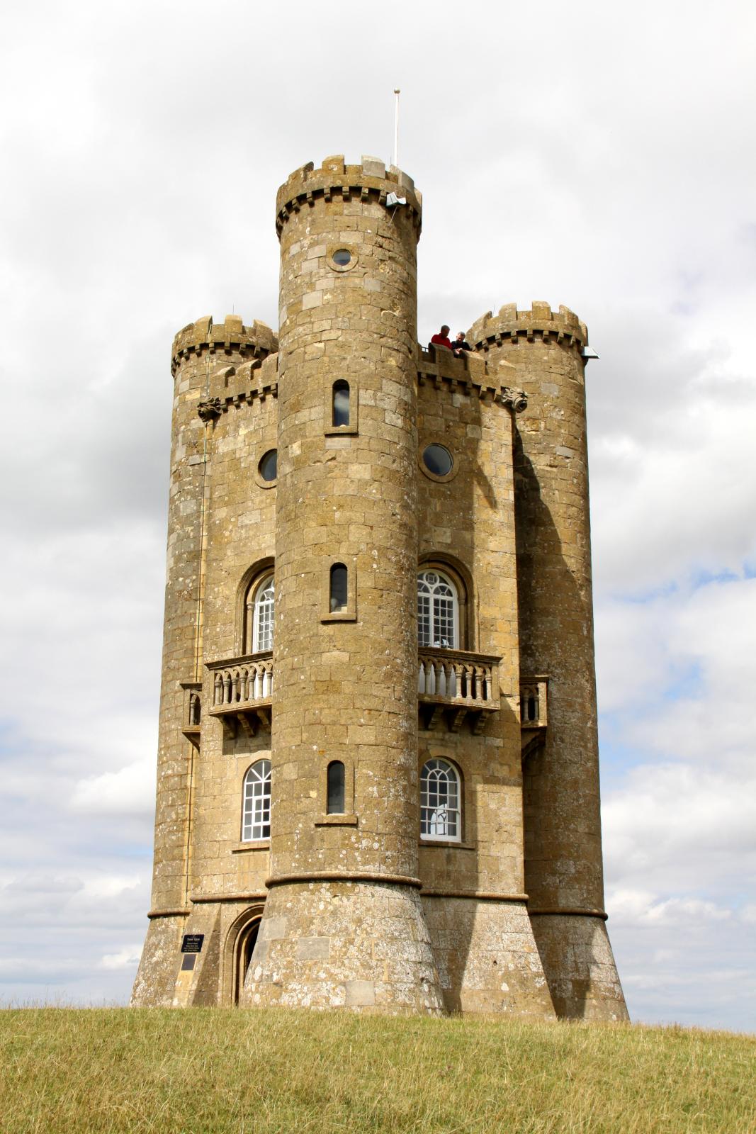 an old, historic tower in a field with grass