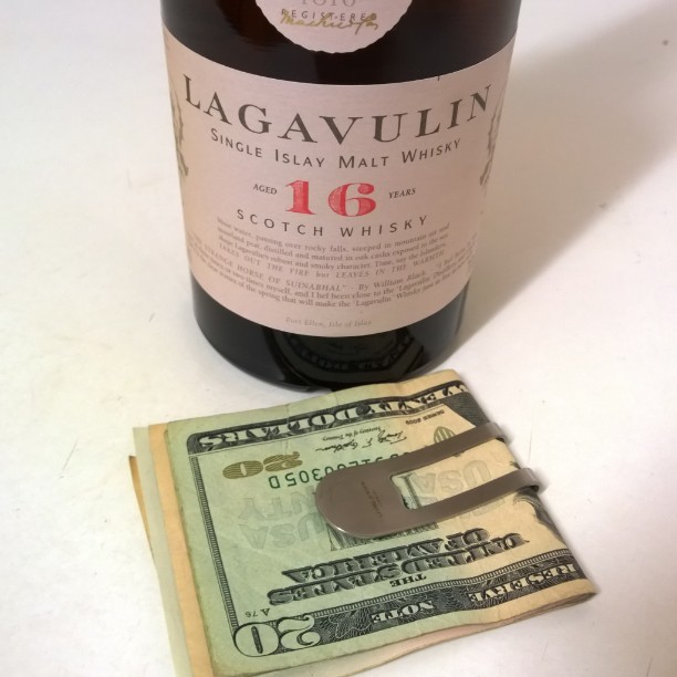 a bottle of wine with money on the side