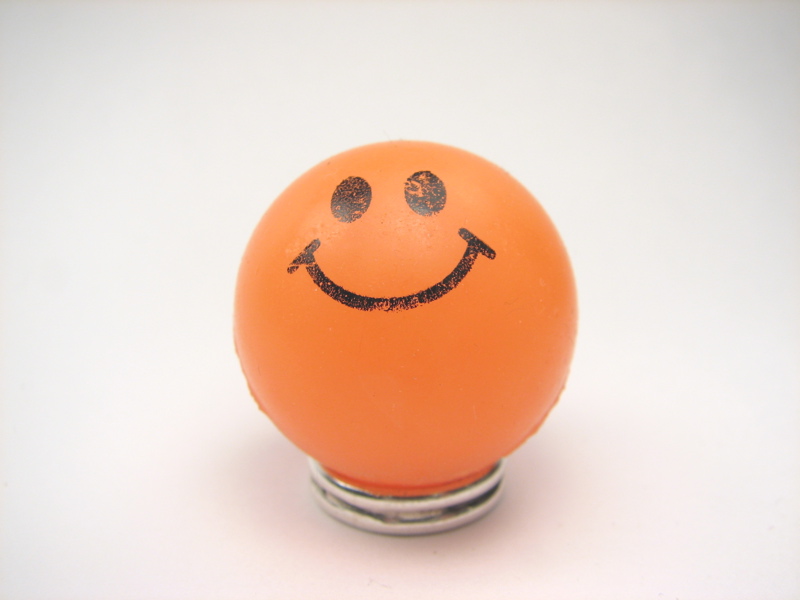 a smiley face is painted on an orange object