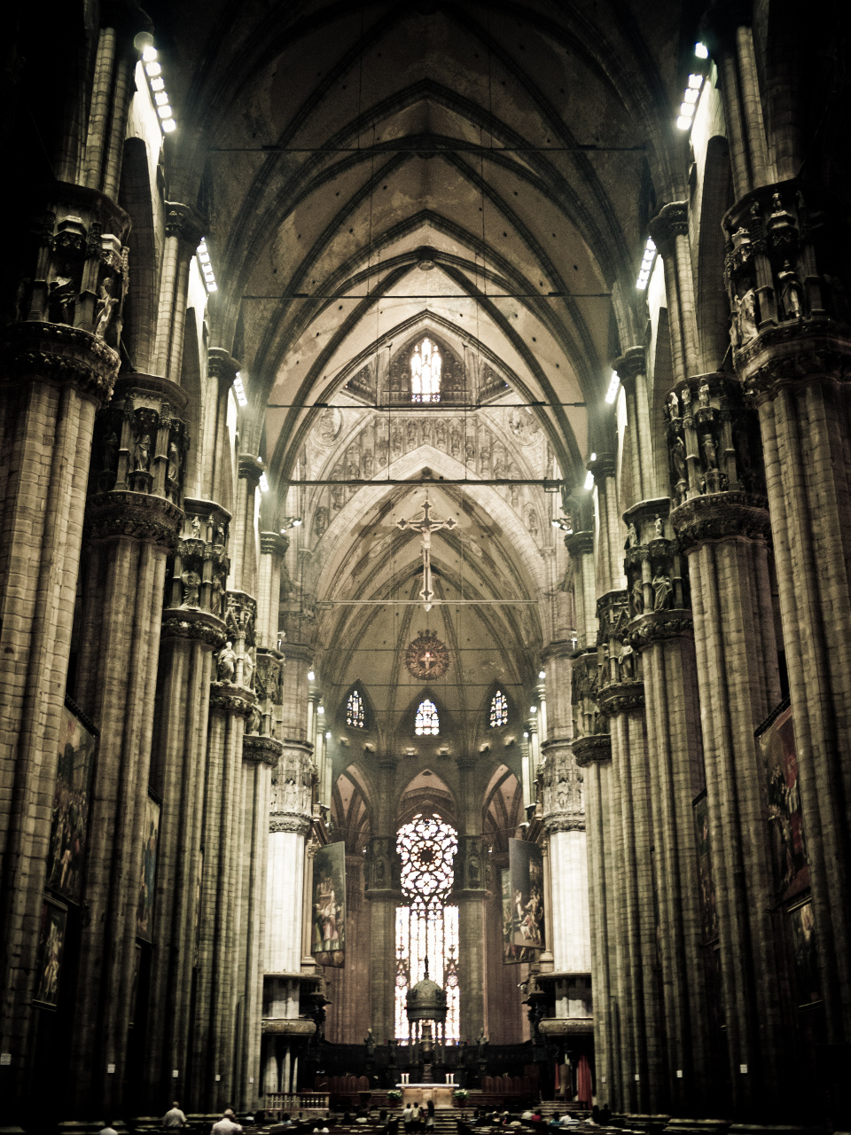 the interior of a church with pews and a chandelier