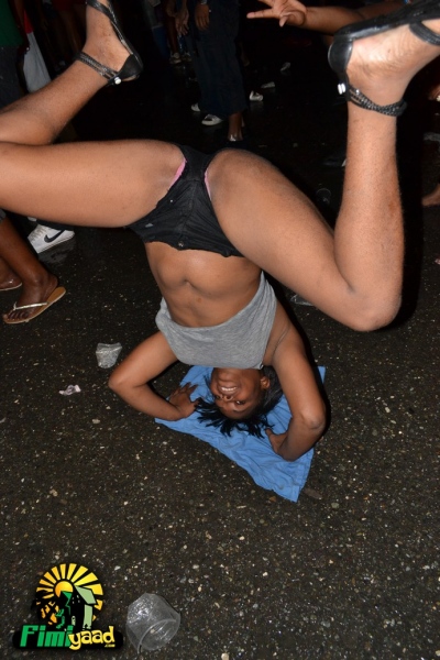a woman performs aerial acrobatic on the ground at an event