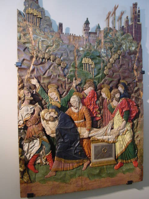 a wall painting with a man laying down next to a group of people