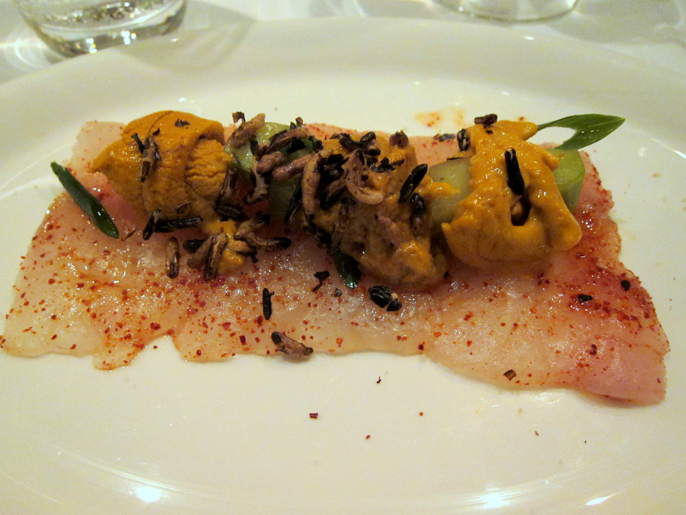 an uncut piece of food sitting on top of a white plate