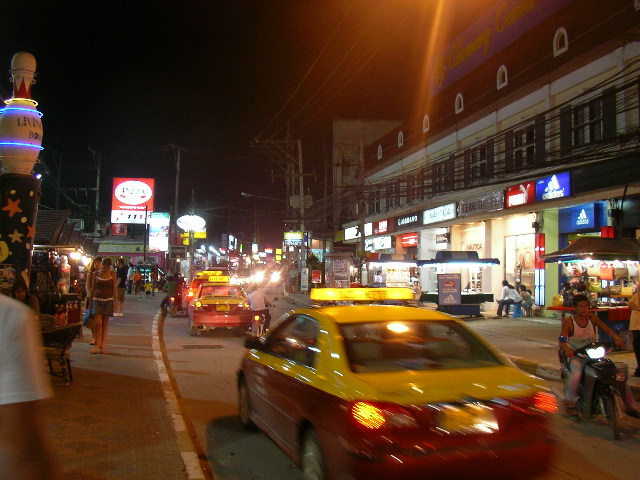 a car driving down a city street at night