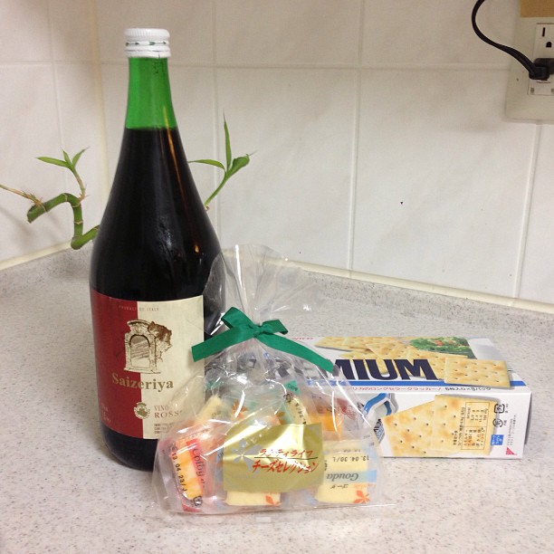 a bottle of wine, ers and two bags of ers on a counter