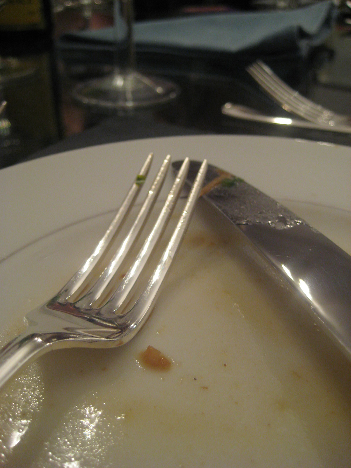 a white plate with a silver fork and knife