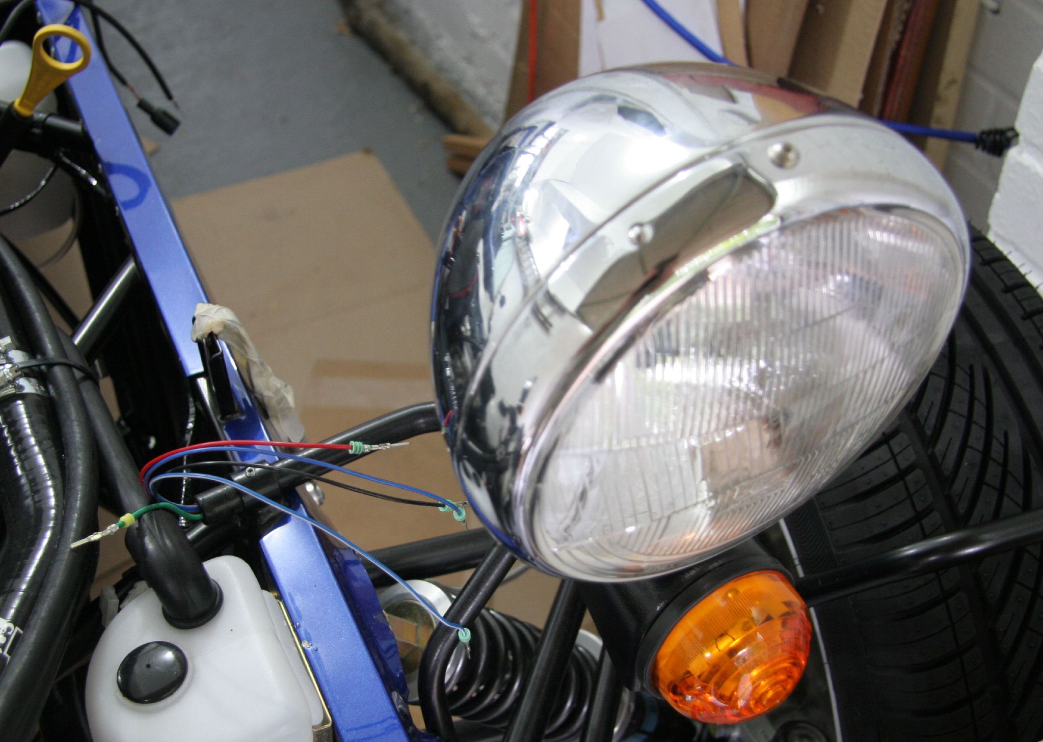 a picture of a motorbike with the headlights on