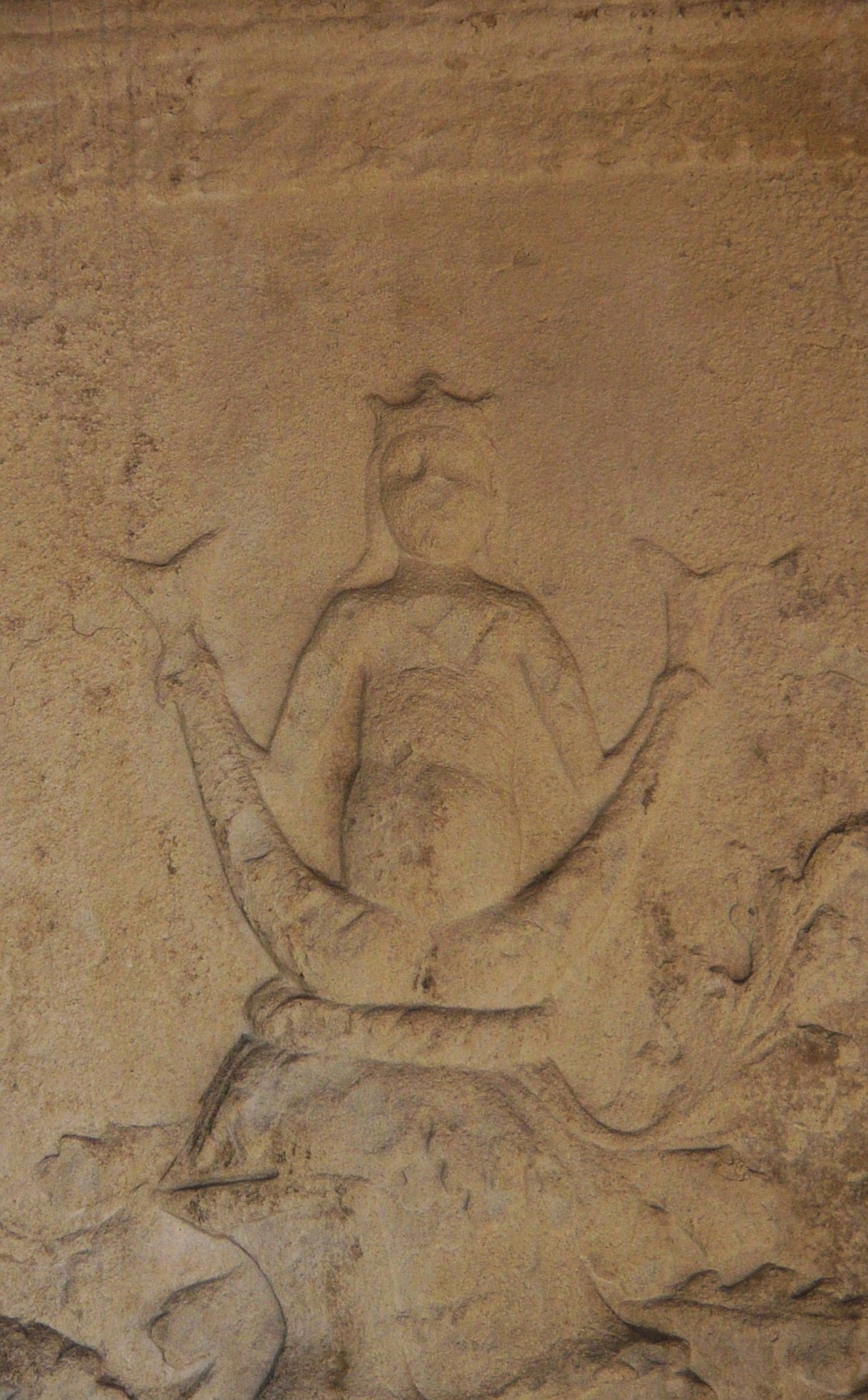 a drawing on a rock wall depicts a man in the desert