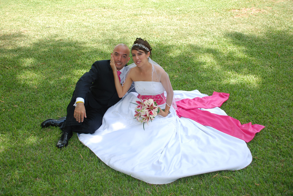 a man and a woman dressed in wedding attire on grass