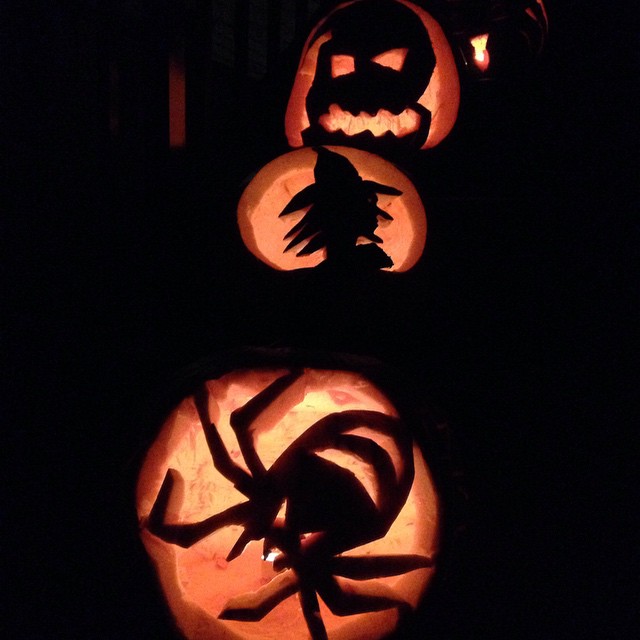 carved pumpkins with scary faces displayed in dark setting