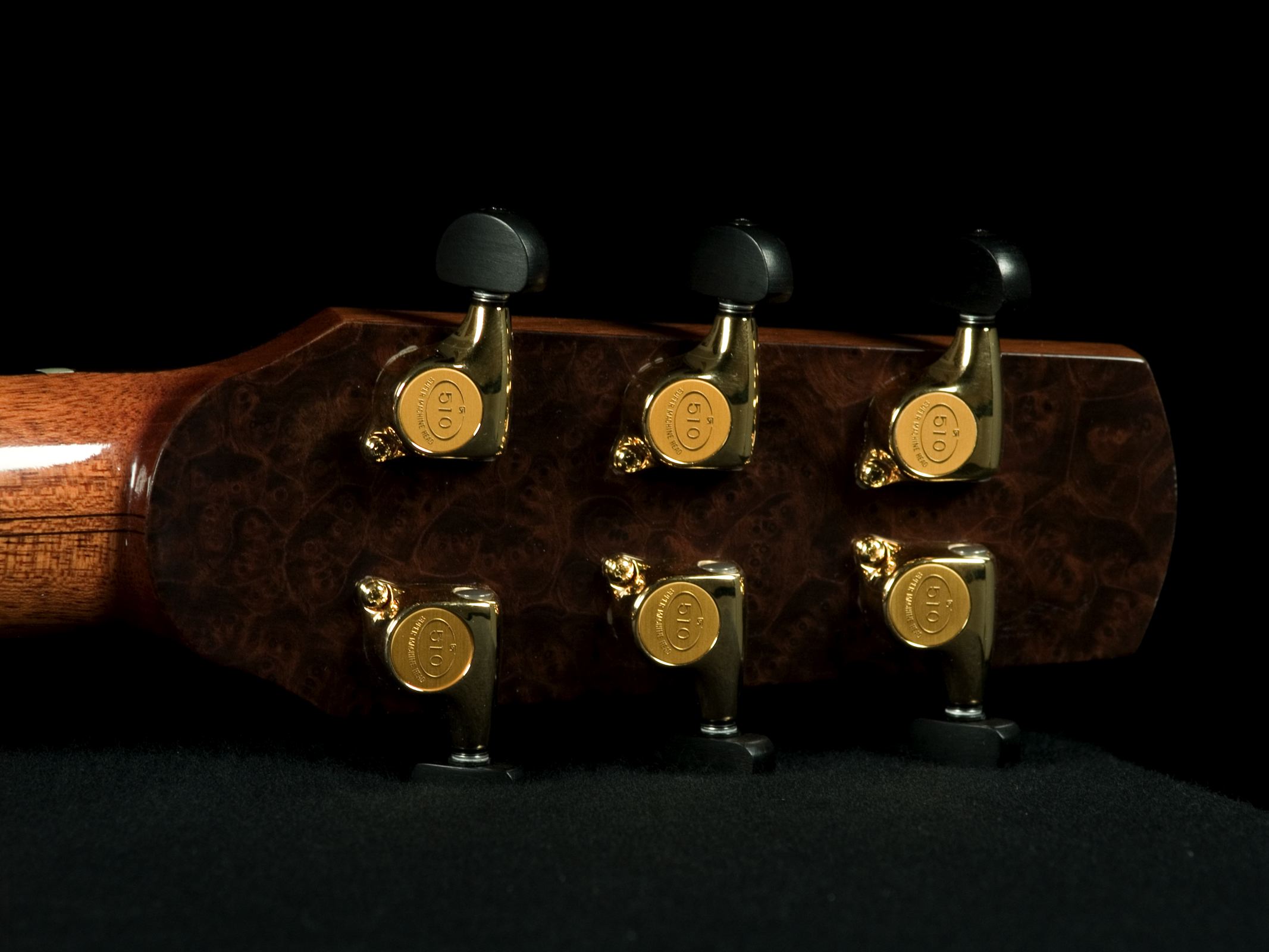 four small ss cufflinks on top of an aged guitar