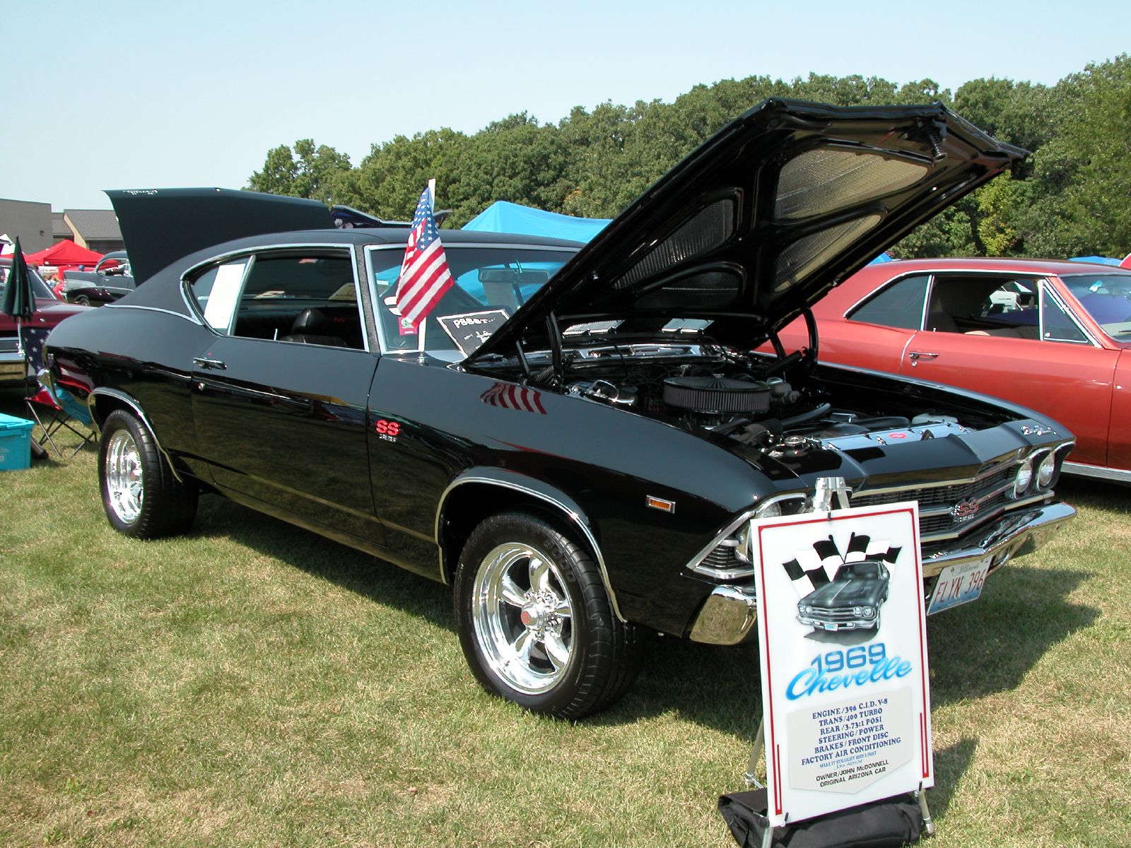 a black car with its hood open on display