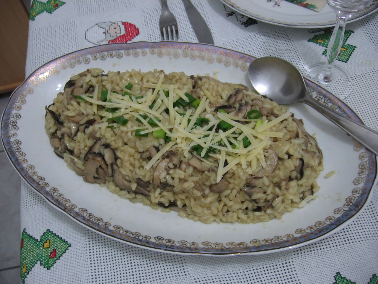 plated food consisting of rice with broccoli and mushrooms on it