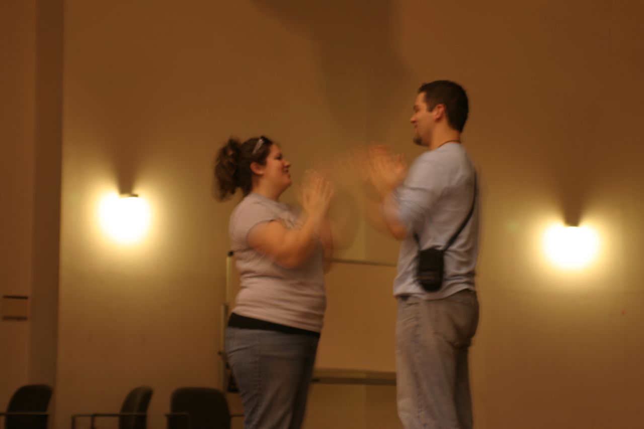 man and woman clapping during performance on stage