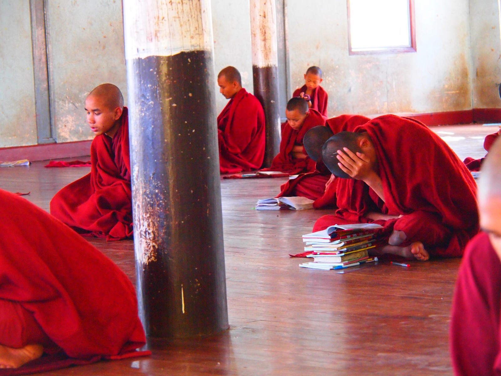 monks sitting in the ground waiting for soing to happen