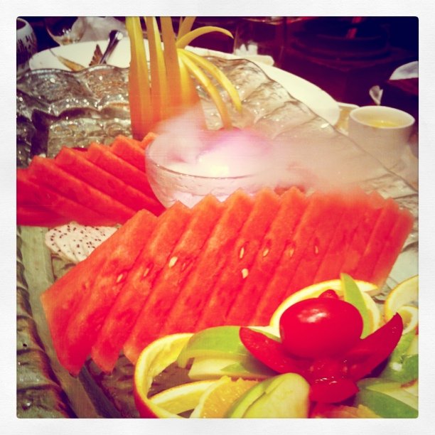 slices of fruit on a plate with water and ice