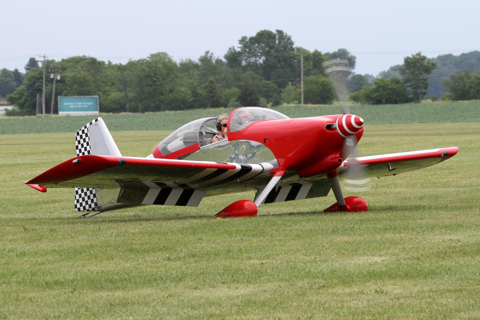 a small aircraft on the ground in a field
