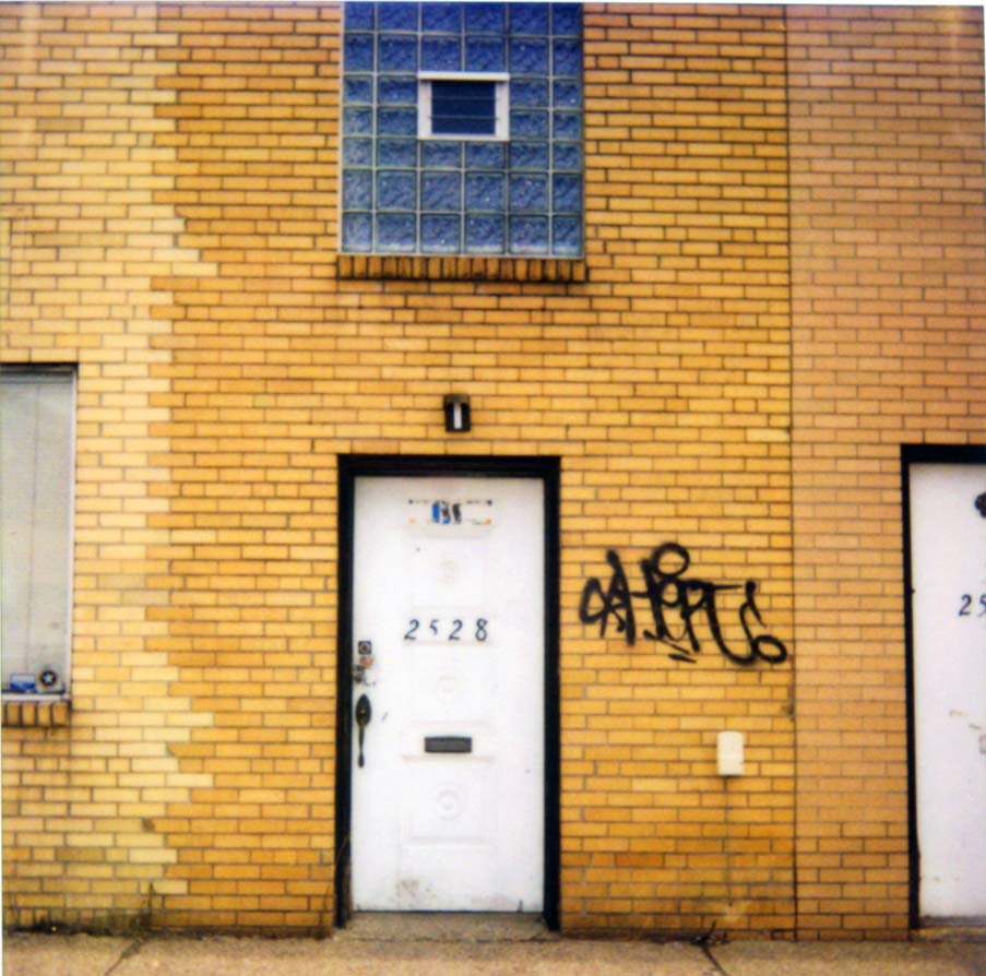 there is a building with graffiti on the wall and doors
