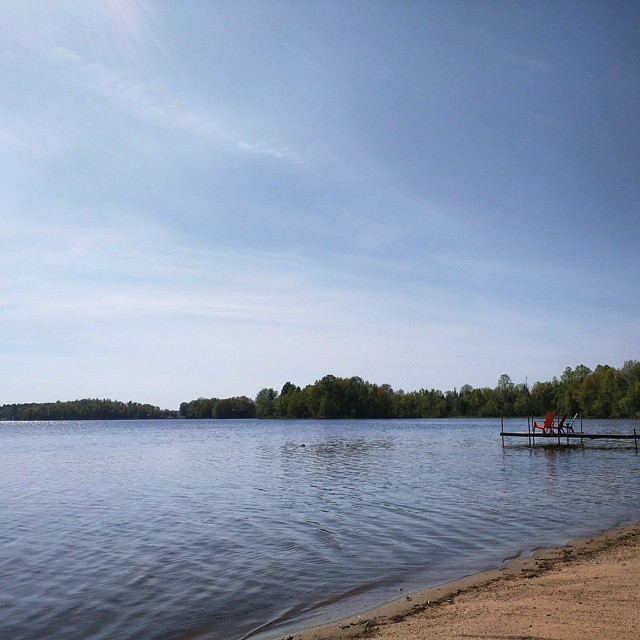 a lake with people on it sitting on a dock