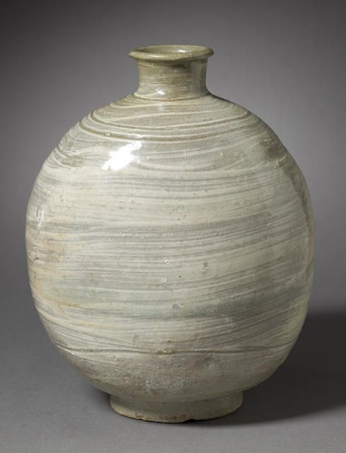 a large white vase that has some kind of design on it