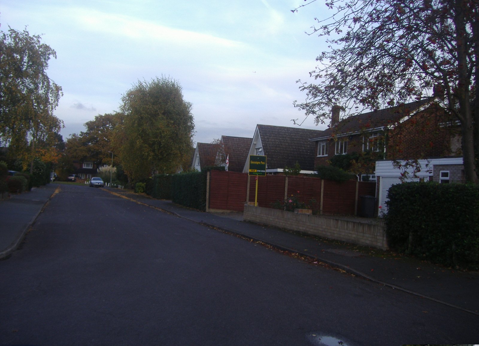 a long stretch of road next to houses