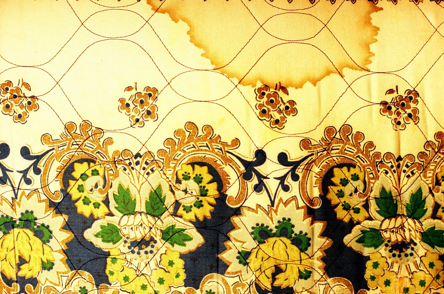 ornate pattern made from fabric showing yellow green flowers