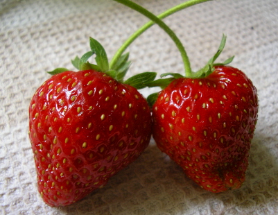 two large strawberries are on the table