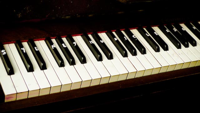 a po of a piano with white keys and black accents