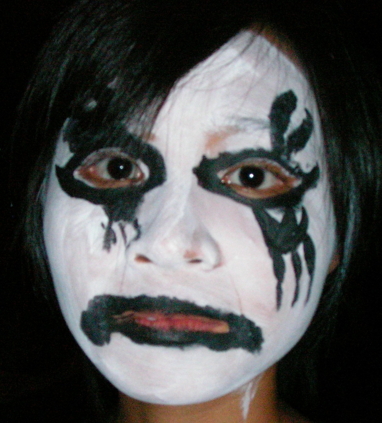 a woman with black makeup on her face