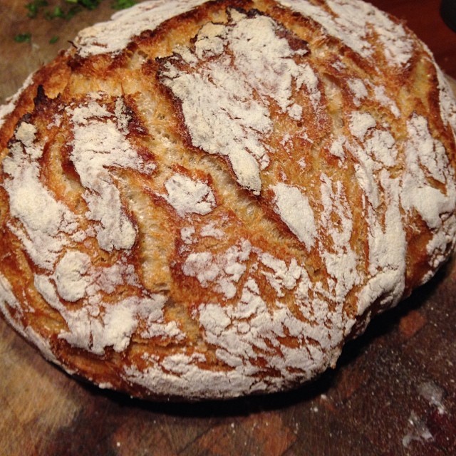 a soury piece of bread sits on a wooden table