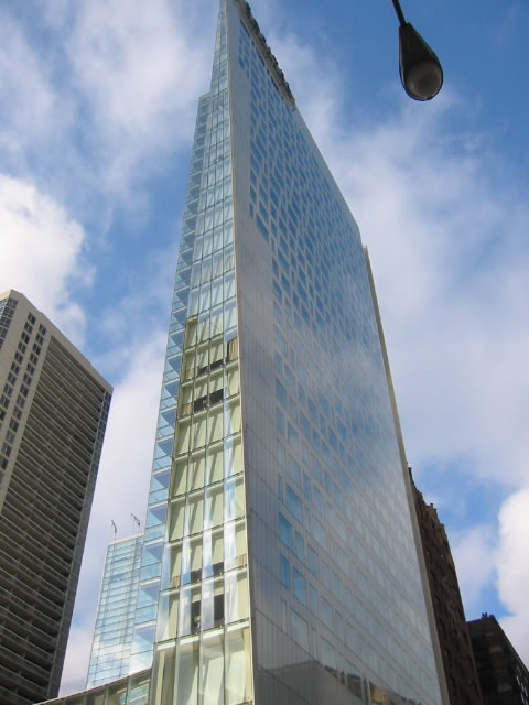 the skyscr is surrounded by other tall buildings