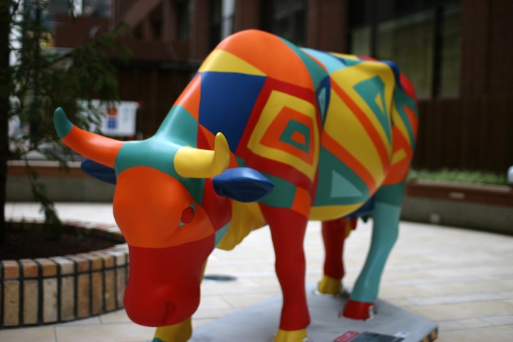 the colorful sculpture has a large bull on top