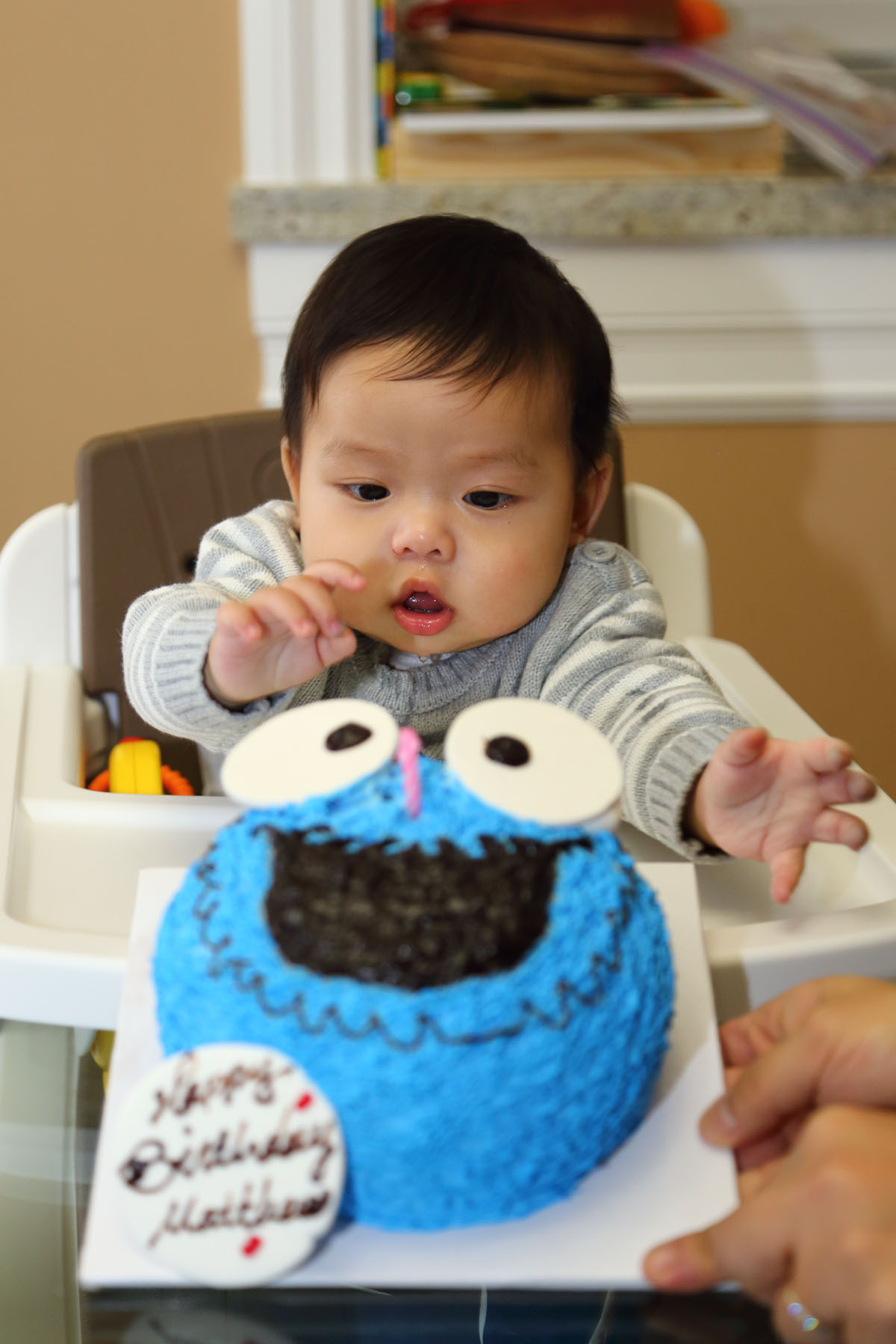 there is a baby with his hand on the table