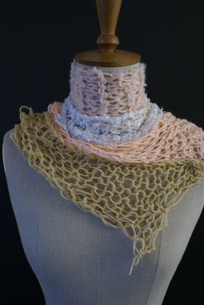 a woman's beige, peach and white scarf