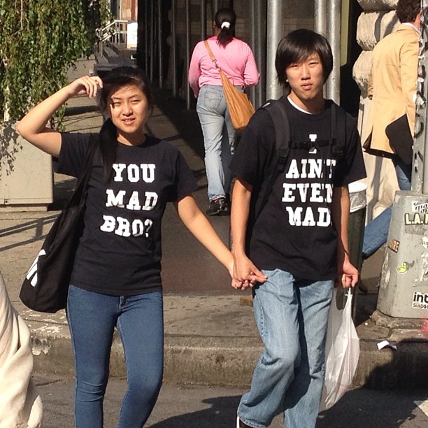 a young man and woman walking on the street